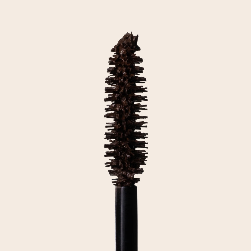 Close-up of the L.A. Girl Jetsetter Mascara Dark Brown applicator brush coated with mascara.